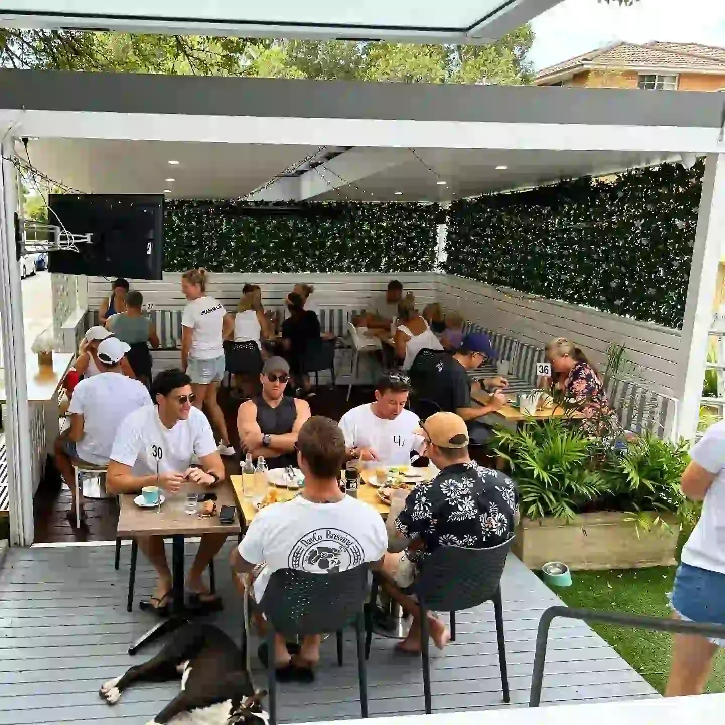 Friends at tables in Chapman Lane's covered rear cabana